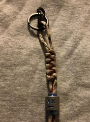 Keychain or knife lanyard. Bag, backpack, jacket zipper pull. Sad-smiley face
