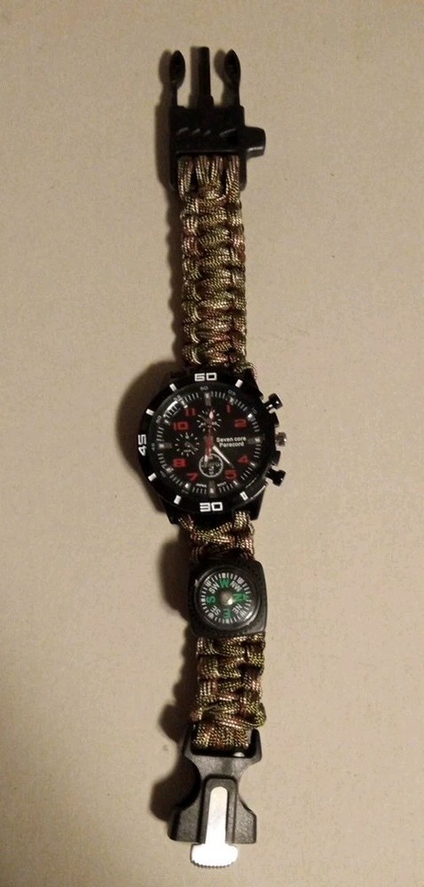 A Survival Watch with Paracord Wrist Band, Saw Blade, Whistle And Compass!