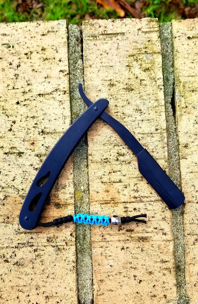 Straight blade razor with custom paracord micro lanyard.
