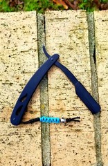 Straight blade razor with custom paracord micro lanyard.