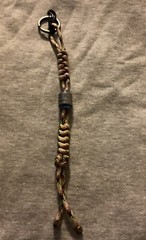 Keychain or knife lanyard. Bag, backpack, jacket zipper pull. Sad-smiley face