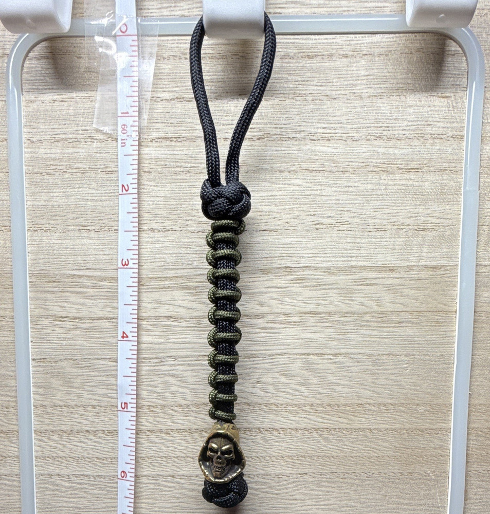 Handmade Black/Green 6 in 550 lb paracord lanyard w/ metal grim reaper bead.